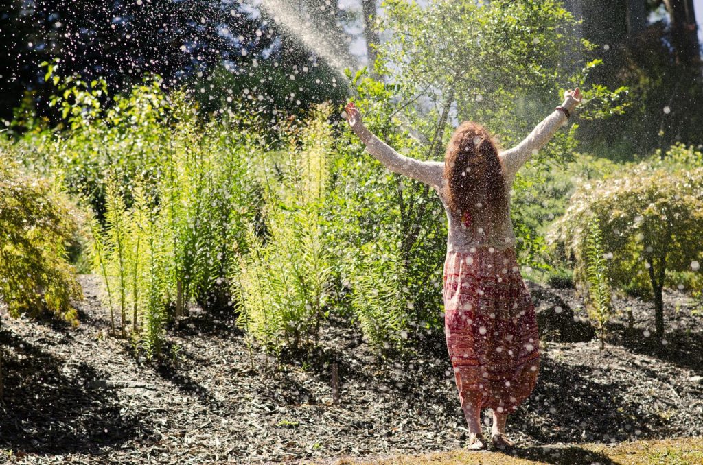 Woman standing blissfully in the rain